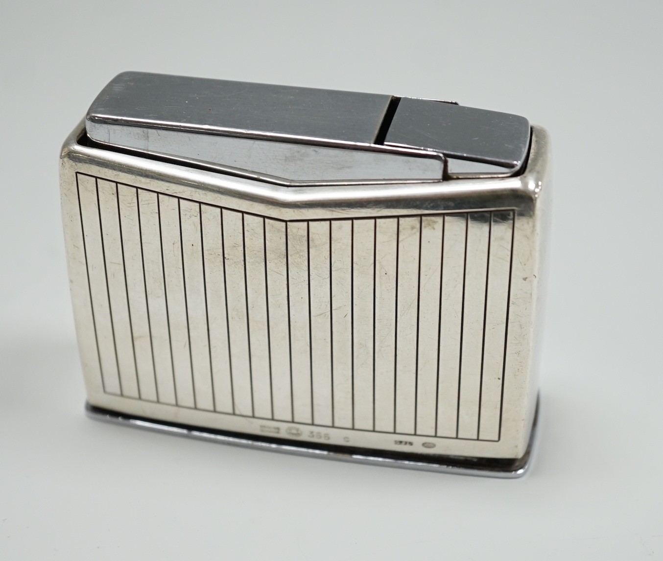 A George Jensen silver mounted lighter, no. 366, width 84mm.